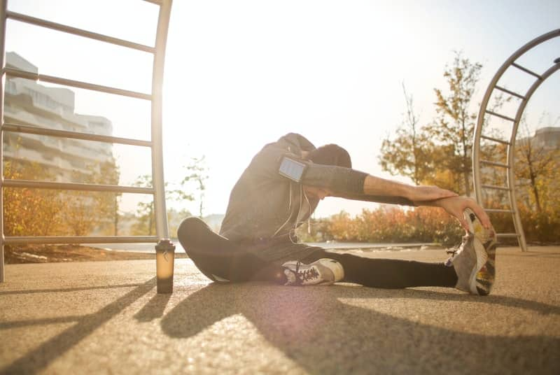 Man that takes nitric oxide boosters stretching before exercise