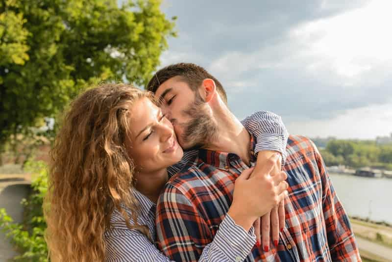 Man kissing woman