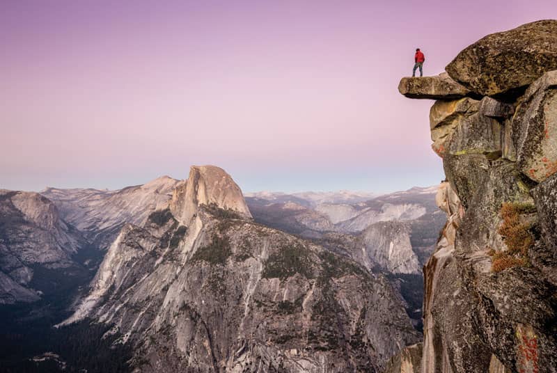 Man standing on cliff edge to represent edging technique