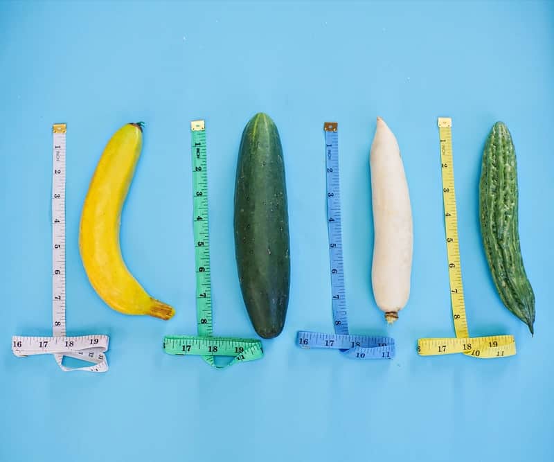 Four penis shaped fruits being measured next to each other