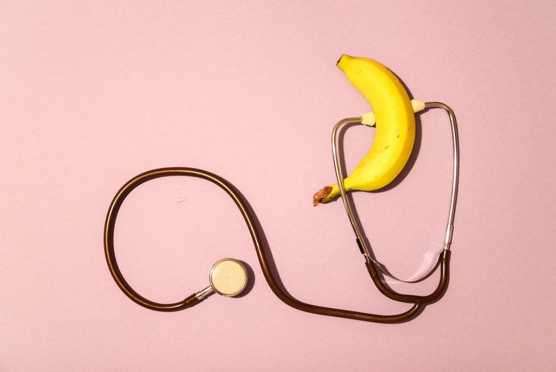 stethoscope on banana to represent healthy erectile function because of nitric oxide boosters