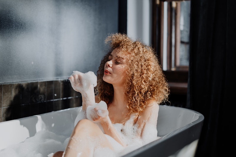 Woman bathing to prevent smegma