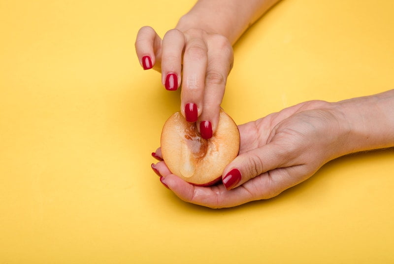 Woman fingering fruit like vagina