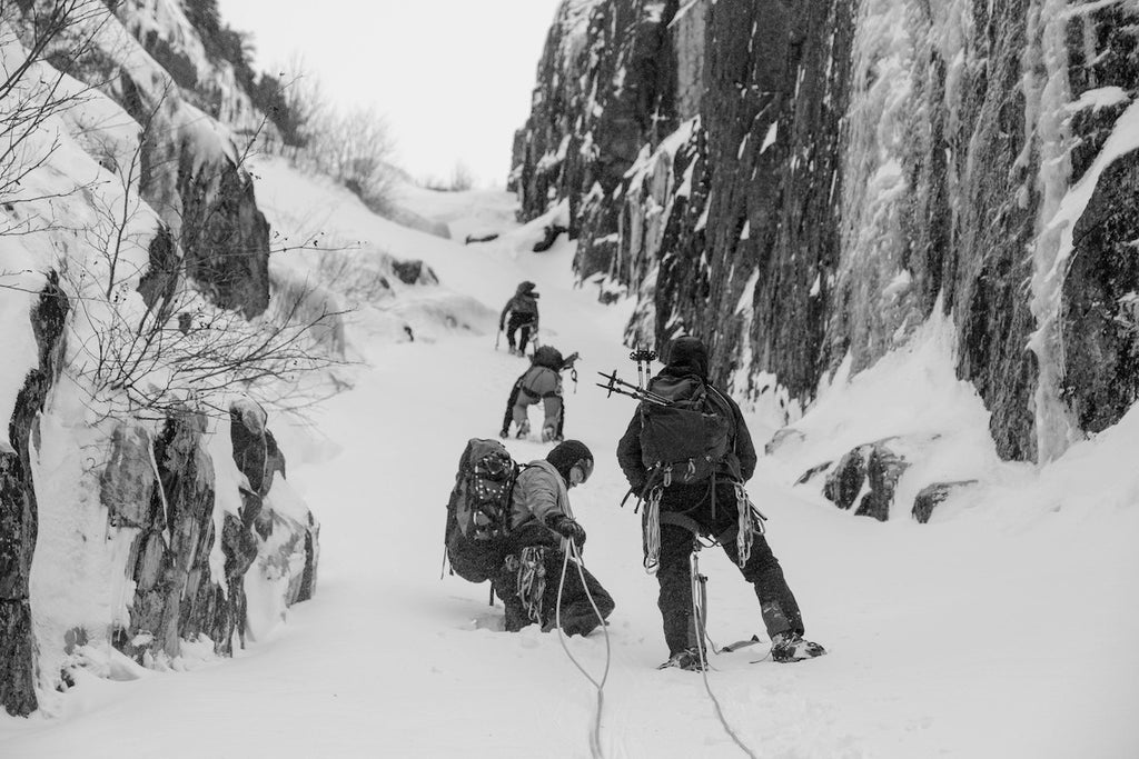 Climbers ascend a snowy pass