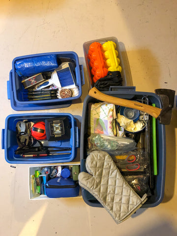 5 neatly organized bins of camping gear