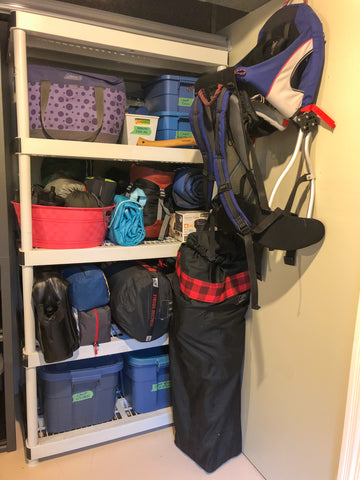 A tidy shelf full of neatly organized camping gear
