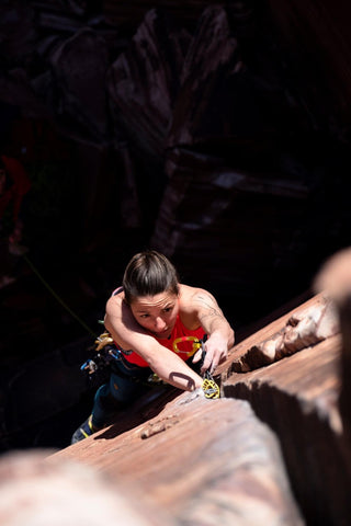 Tori Silvera climbs a rock face