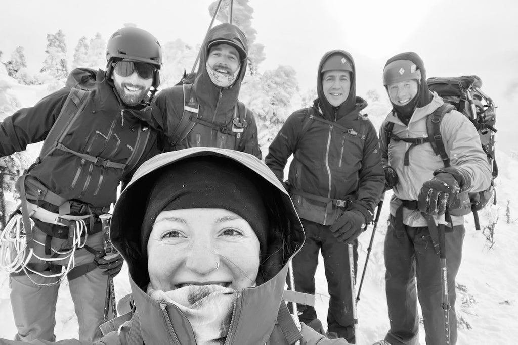 A team of winter hikers smiles for the camera