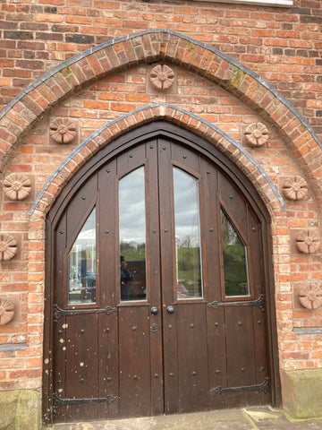 reclaimed brick arch doorway with decorative flower bricks 