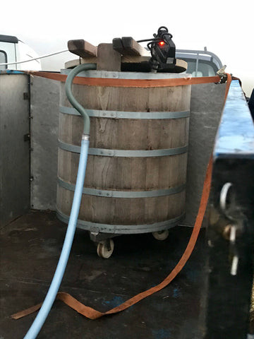 The wooden gerle being filled with milk from the parlour.