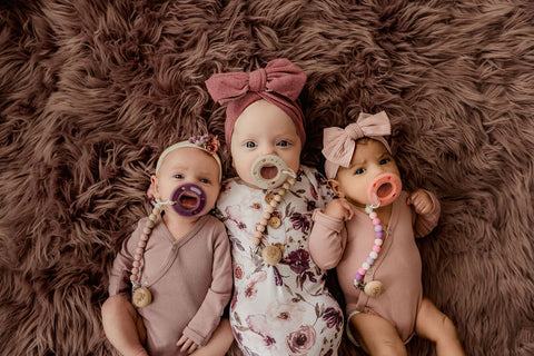 Three adorable babies with ninni pacifiers