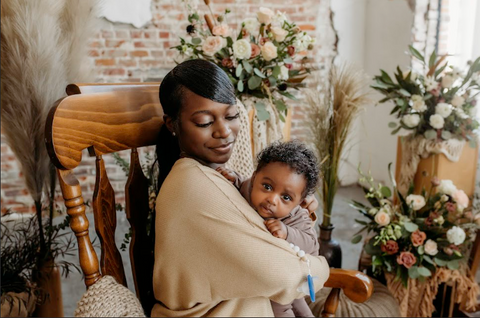 New mom seated with adorable baby looking over her shoulder