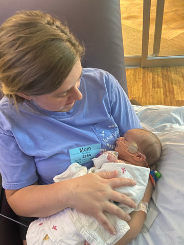 April Wallace cradles her baby daughter in nicu