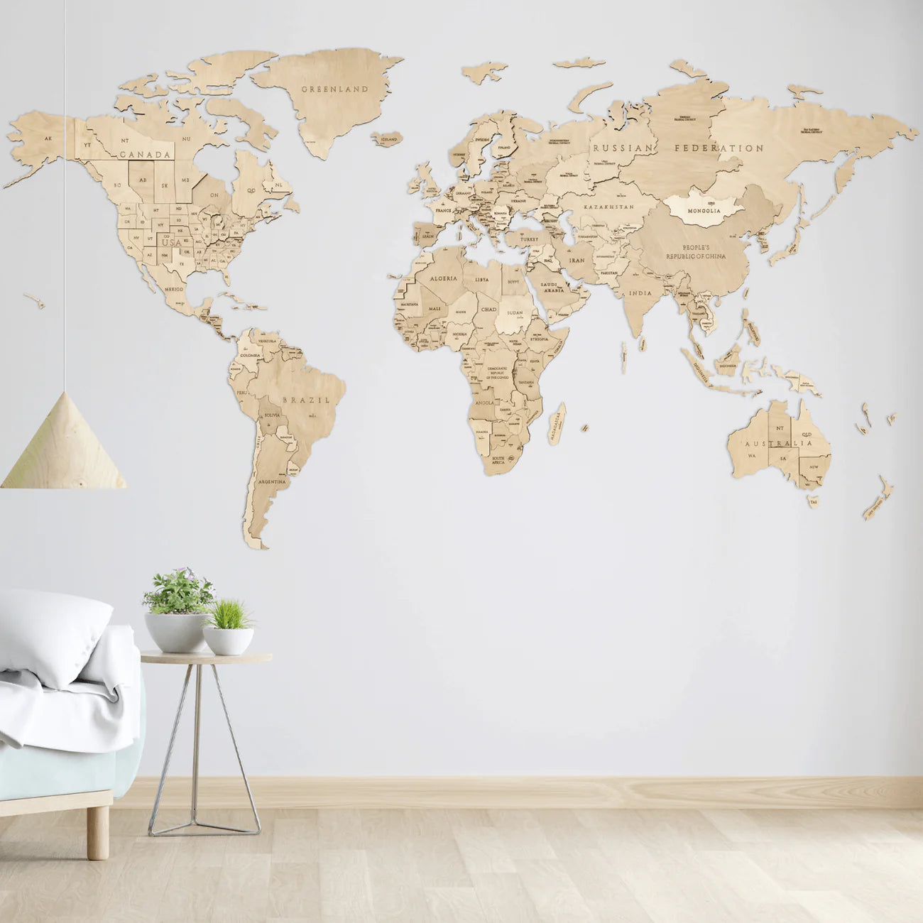 Wooden world map wall art in a minimalist room with a bed, side table, and potted plants.