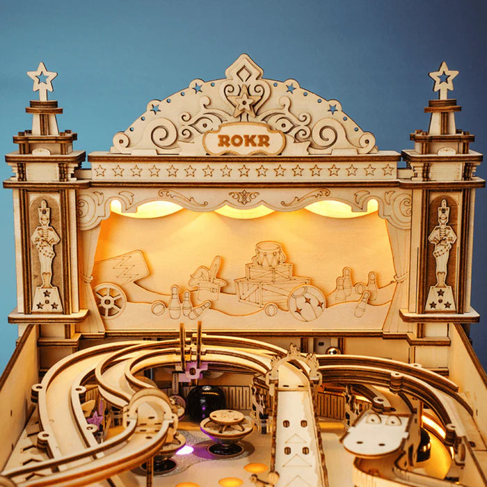 A detailed wooden mechanical model of an amusement park with intricate designs and winding tracks.