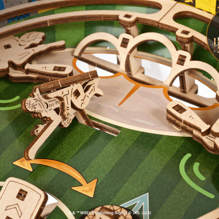 Hands adjusting a mechanical globe with gears on a table.