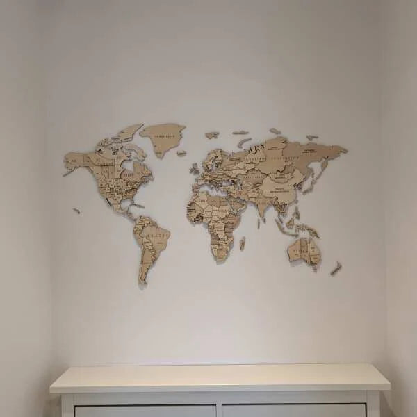 Wooden world map on a white wall above a white console table.