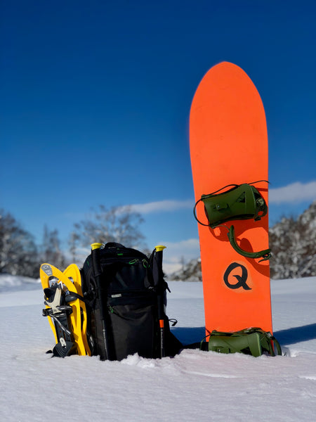 Camera Bag in the Snow with Snowboard