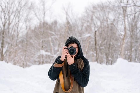 Male Photographer in Snow with Leather Camera Strap