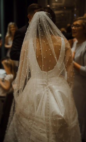 real bride wearing a statement pearl long veil