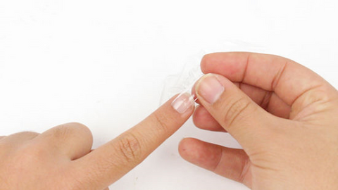 A nail tip is applied to the fingernail