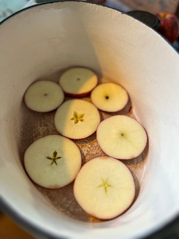 Sliced apple in the bottom of a casserole dish to stop the pork from burning