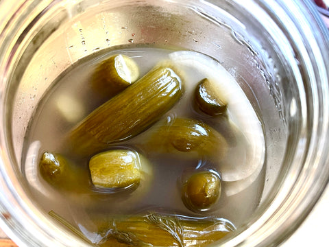 Fermented pickles with brine in a jar