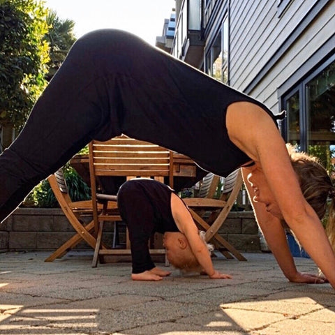 Mama + Toddler doing downward dog in matching Dhoti Onesie Onepiece outfits