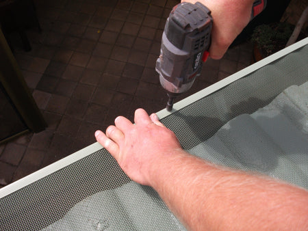 Attach the mesh using the trims on your tiled roof