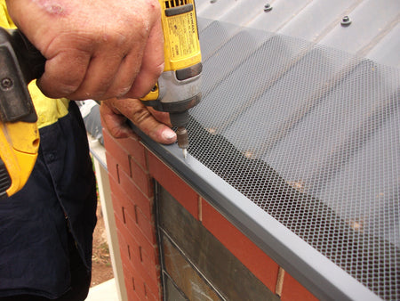 Attach the mesh using the trims on your corrugated roof