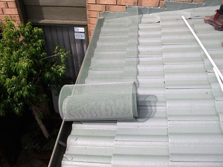 Gutter Guard Being Rolled Out on a Tiled Roof