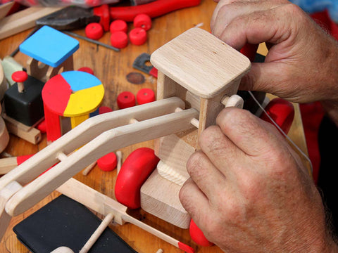 a man building wooden toys