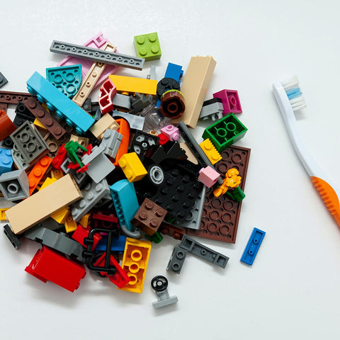 pile of legos next to a toothbrush