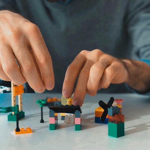 man assembling lego pieces