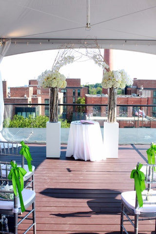 Two simple white pedestals create a beautiful wedding alter.