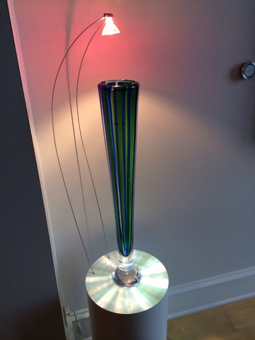 Color controlled overhead light on glass vase