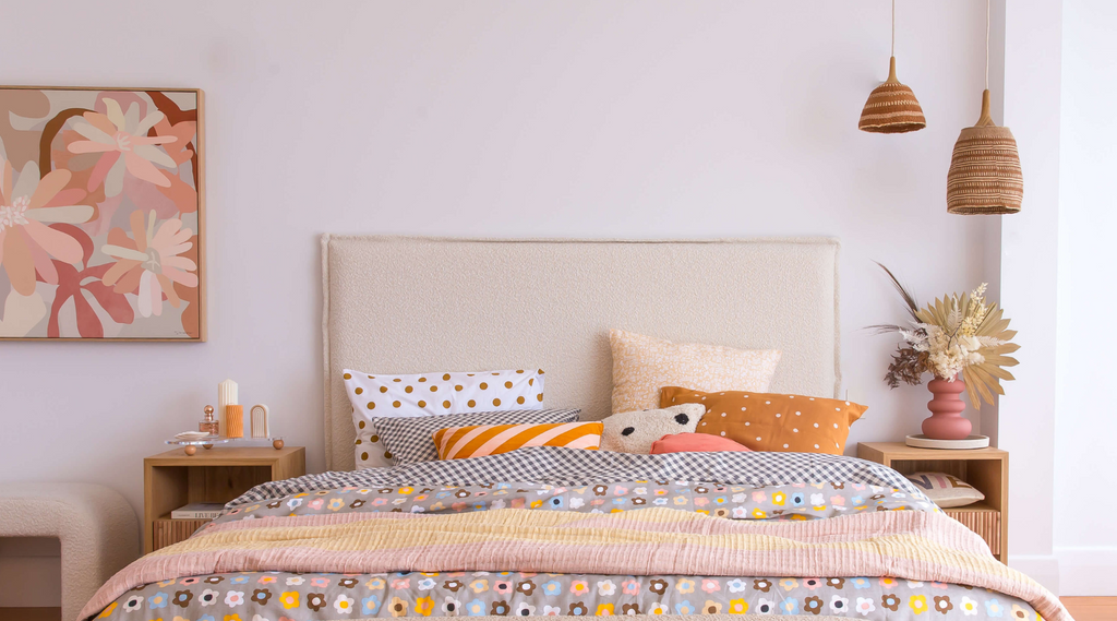 Image of two Caramel Collection pendant lights hanging in a bedroom