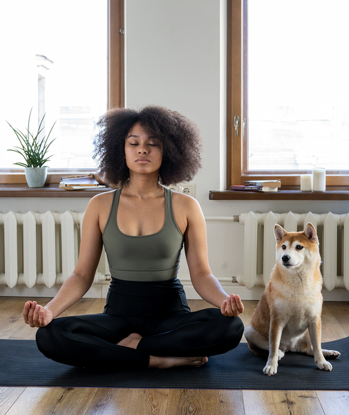 girl doing yoga with her dog