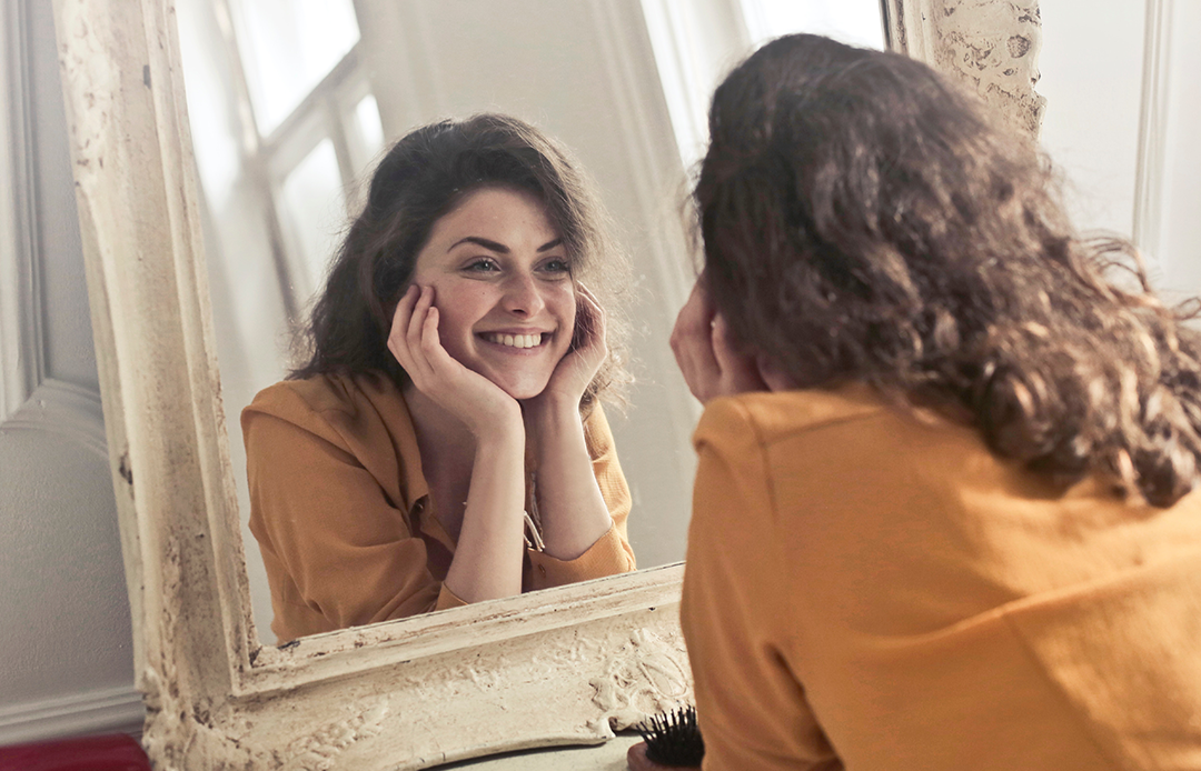 girl smiling in the mirror