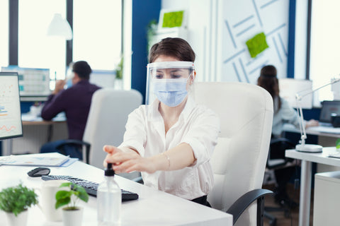A woman with proper covid safety measures in a workplace