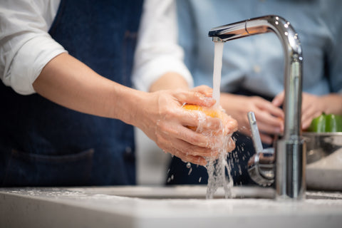 fruits getting washed under running water