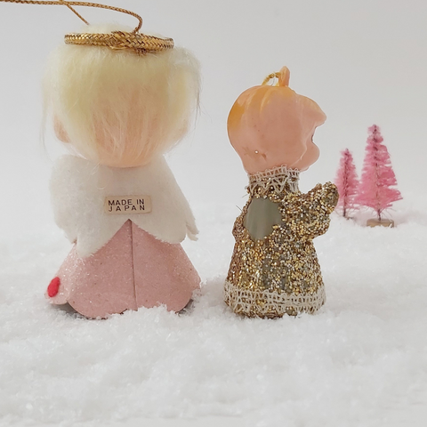 Back view of two mid century style angel ornaments