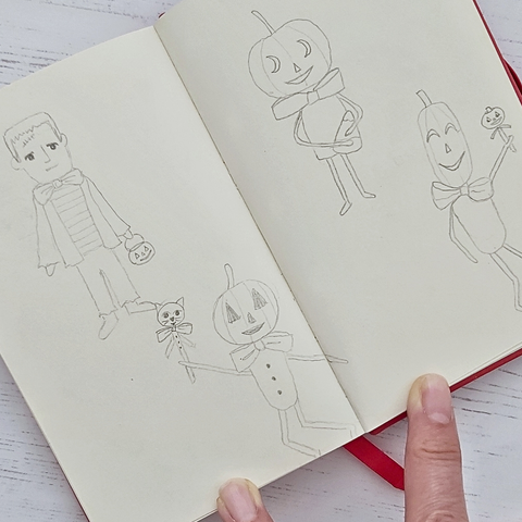 pencil drawings in a sketchbook of pumpkin people and a Frankenstein