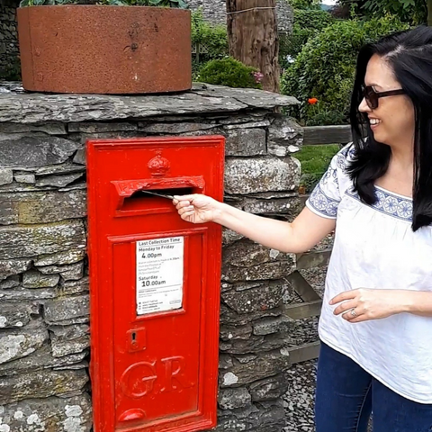 Me putting a postcard in the same post box featured in Beatrix Potter's books 