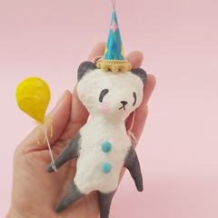 spun cotton panda wearing birthday hat and holding yellow balloon