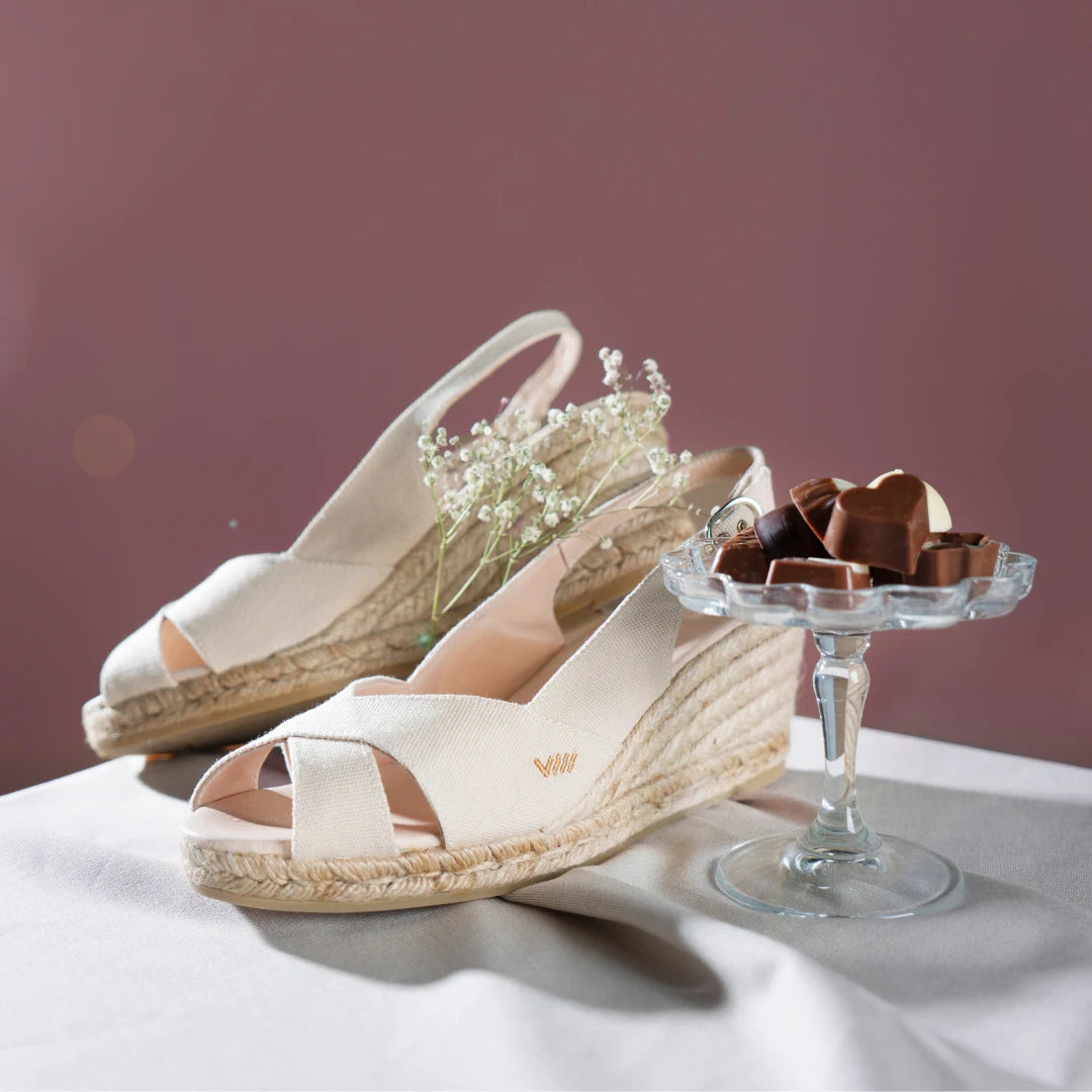 Llansa canvas beige open toe sling back medium wedge espadrilles in a valentine's set up with chocolates