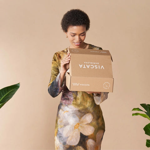 Woman unboxing Viscata espadrille box. Handcrafted espadrille wedges.