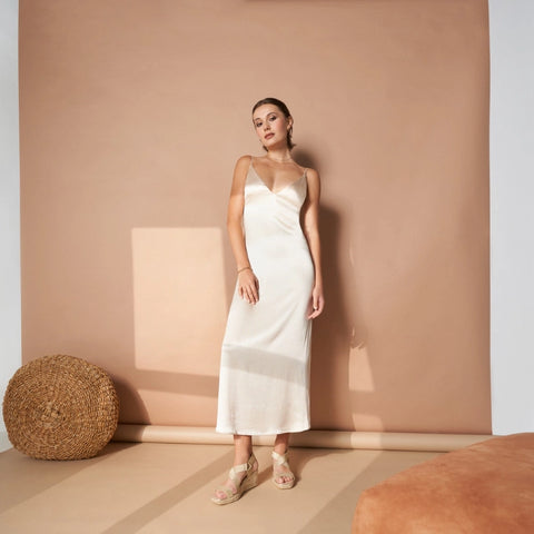 woman wearing white silk dress and gold espadrille sandals