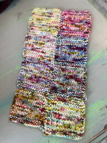 A piece of fuzzy knitted fabric with 8 squares of different colors