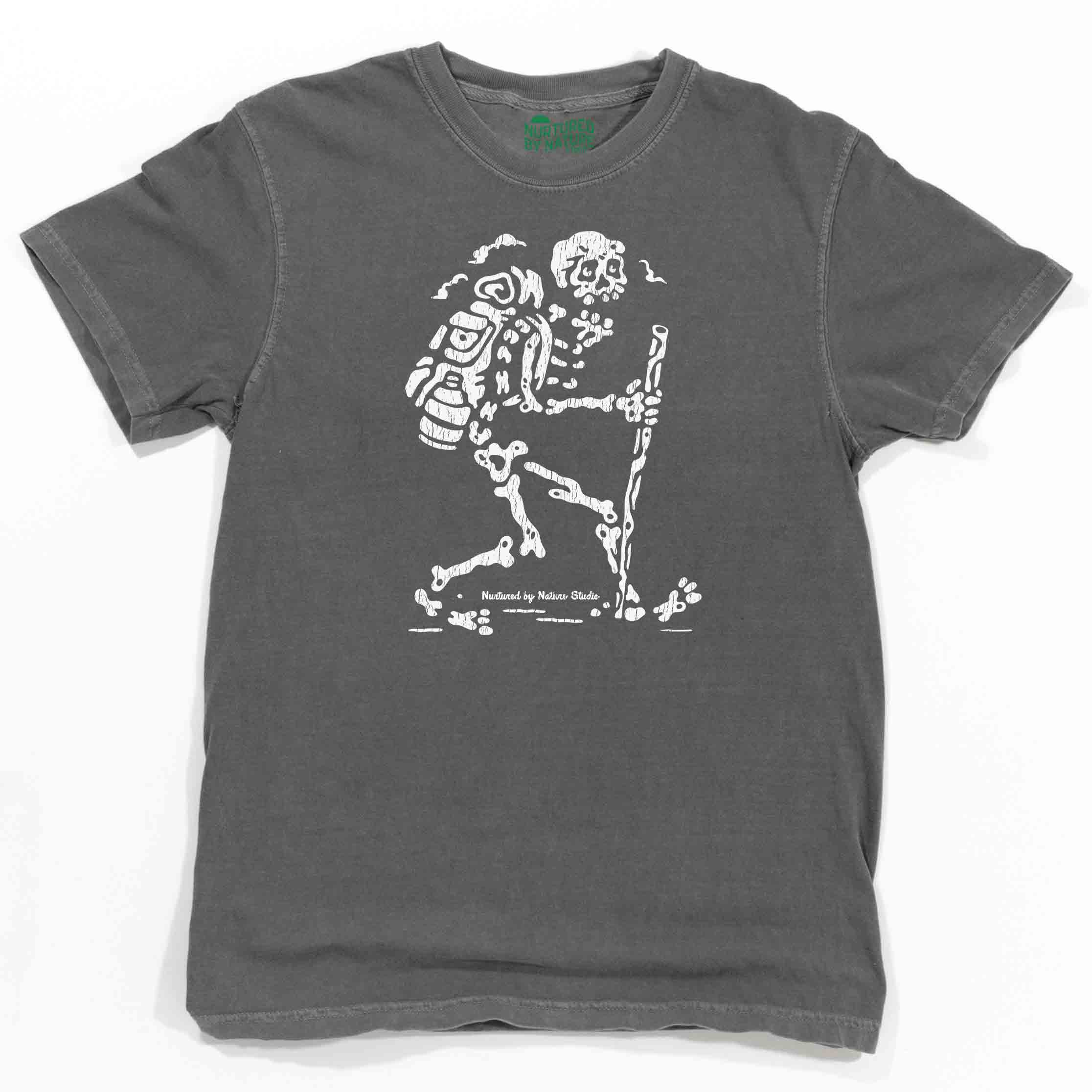 https://cdn.shopify.com/s/files/1/0292/8217/products/Hiking-Skeleton-Graphic-T-Shirt-Nurtured-by-Nature-Studio.jpg?v=1673186238&width=2232